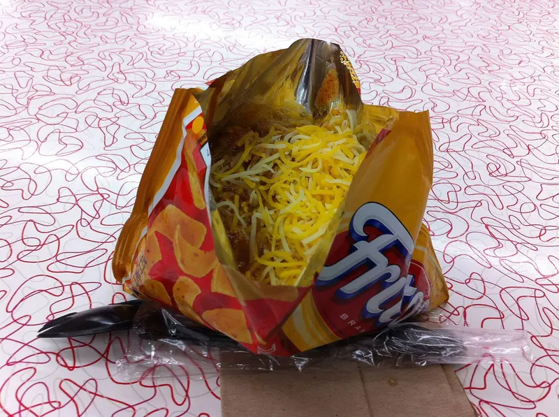 Frito pie topped with shredded cheese in a Fritos bag at the Five and Dime General Store in Santa Fe