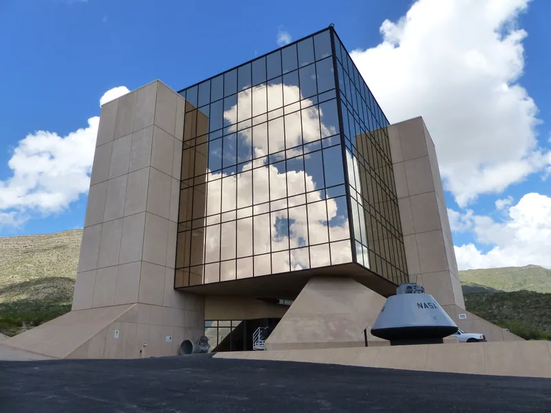 The mirrored New Mexico Museum of Space History building and an outdoor space capsule in Alamogordo