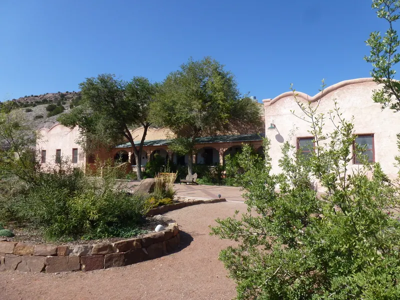 The adobe facade and landscaped courtyard at Ojo Caliente Mineral Springs, photographed in 2012