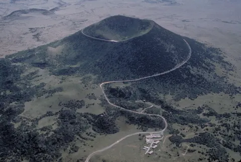 Aerial view of Capulin Volcano and the road winding up its cinder cone