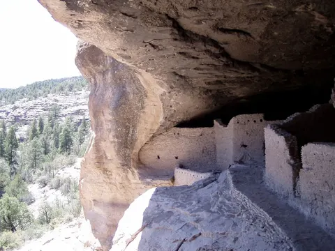 Stone dwellings sheltered beneath a rock alcove at Gila Cliff Dwellings