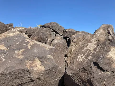 Petroglyphs carved into volcanic boulders in Boca Negra Canyon