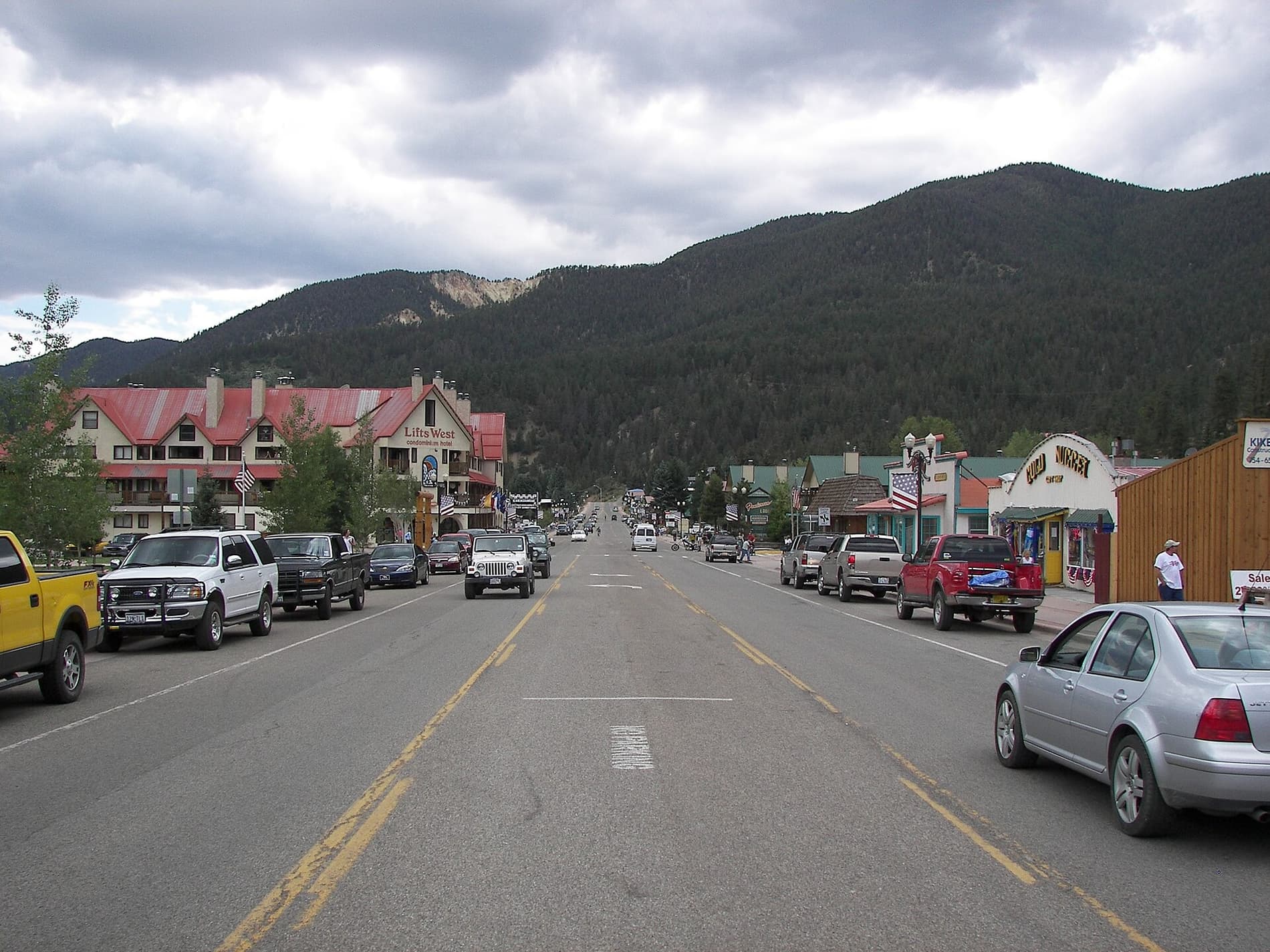 Main Street in the town of Red River, New Mexico, with the forested ski mountain rising directly behind the buildings
