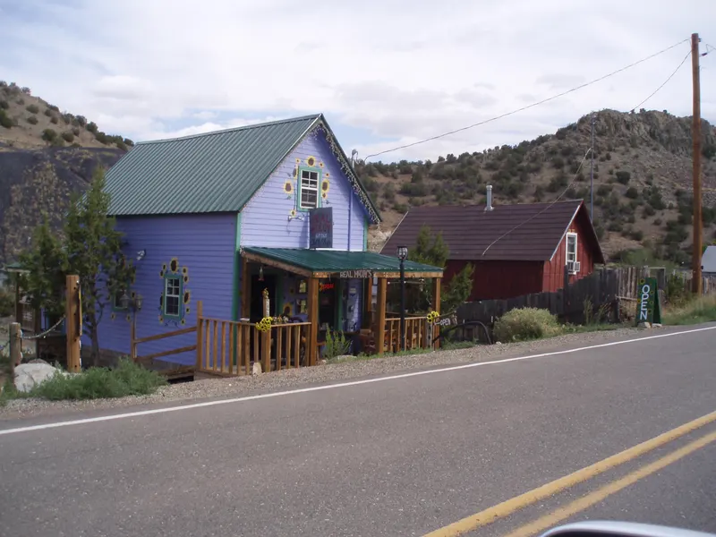 Purple and red shop buildings along the main road in Madrid, New Mexico