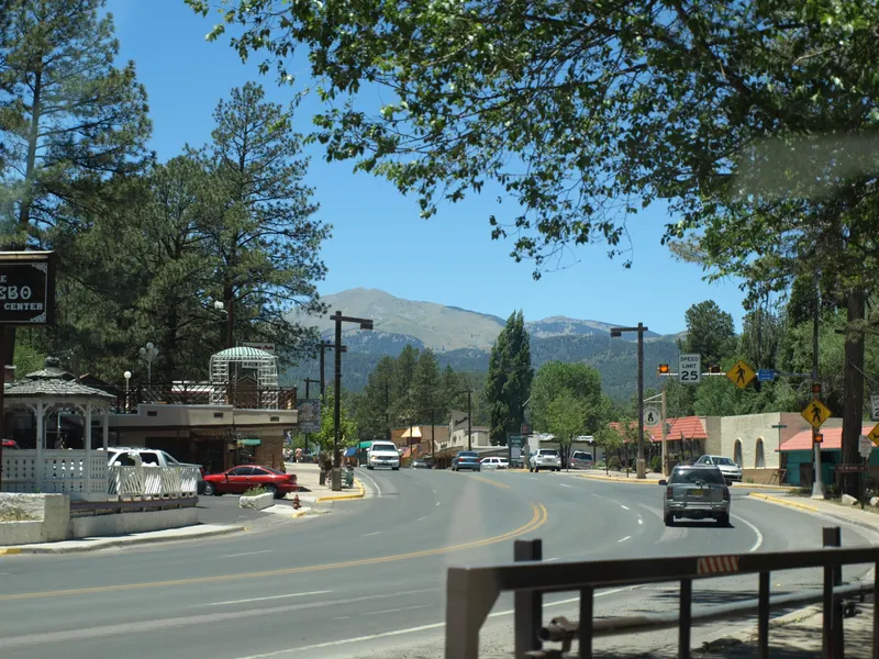 A tree-lined street in downtown Ruidoso with Sierra Blanca in the distance, photographed in 2008